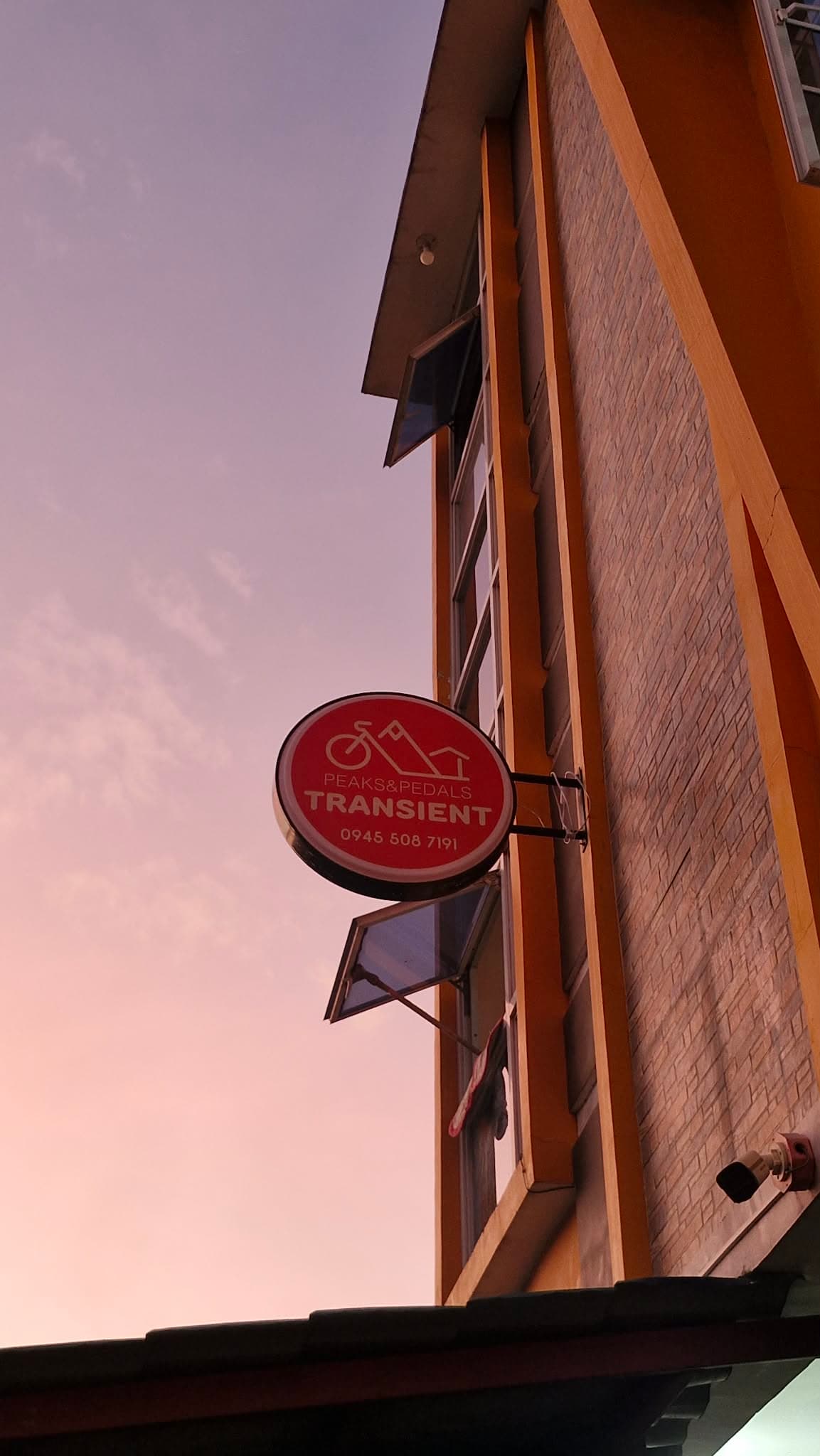 Peaks & Pedals signage at dusk